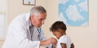 Doctor listening to toddler's heart