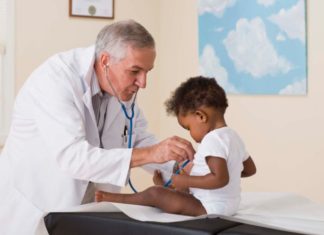 Doctor listening to toddler's heart