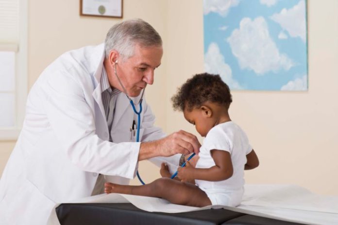 Doctor listening to toddler's heart