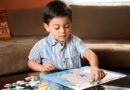 Boy putting puzzle together