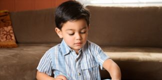 Boy putting puzzle together