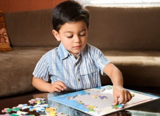 Boy putting puzzle together