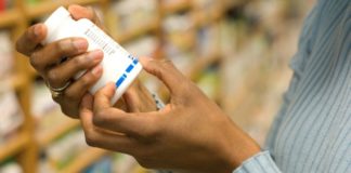 Woman examining pill bottle