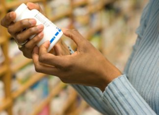 Woman examining pill bottle