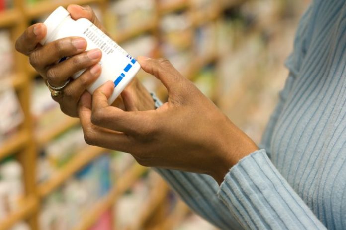 Woman examining pill bottle