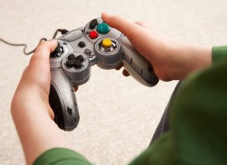 A boy's hands on a video game controller.