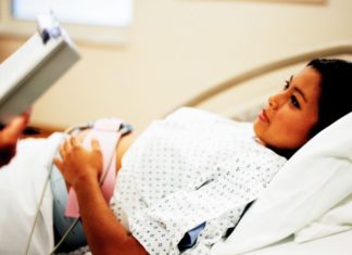 Pregnant woman in hospital gown