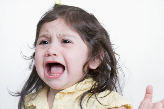 Studio shot of crying toddler girl.