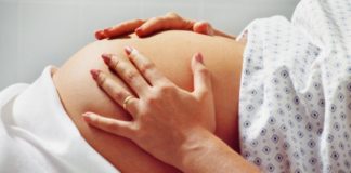 Pregnant woman in hospital gown