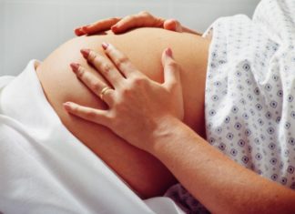 Pregnant woman in hospital gown