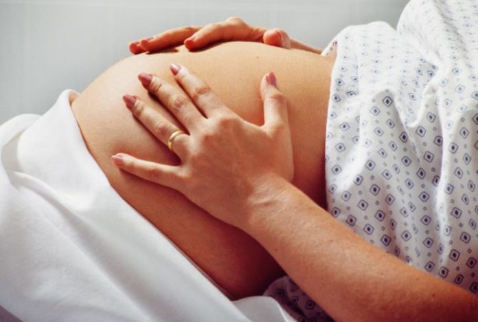 Pregnant woman in hospital gown