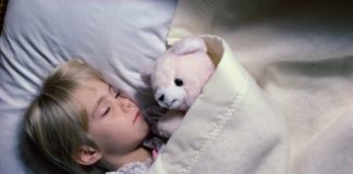 Boy sleeping with teddy