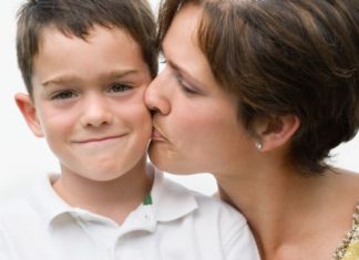 Mother kissing son