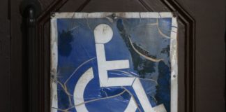 Shattered glass over a disabled sign.