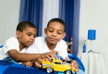 Brothers playing with toy car
