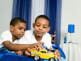 Brothers playing with toy car