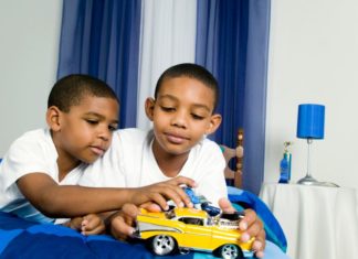 Brothers playing with toy car