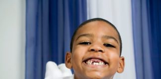 Portrait of smiling boy with missing front teeth.