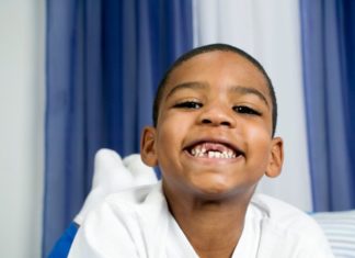 Portrait of smiling boy with missing front teeth.