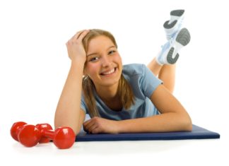 Smiling woman posing on exercise mat