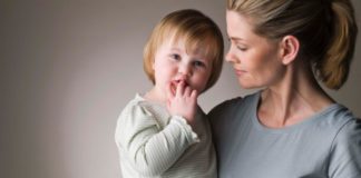 A mum holds her toddler.