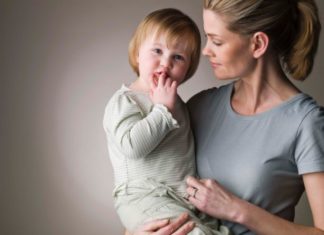 A mum holds her toddler.