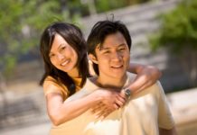 Couple in the sun in a park.