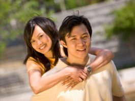 Couple in the sun in a park.