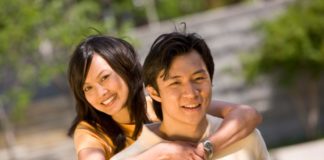 Couple in the sun in a park.