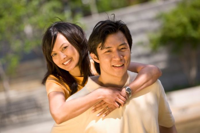 Couple in the sun in a park.