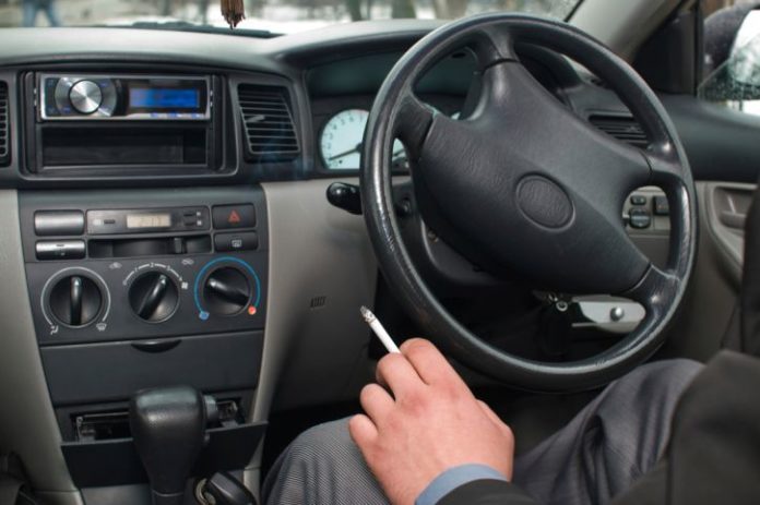 Man smoking in car