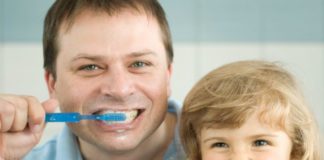 Dad and daughter brushing teeth