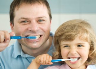 Dad and daughter brushing teeth