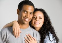 Close up shot of a couple smiling to camera.