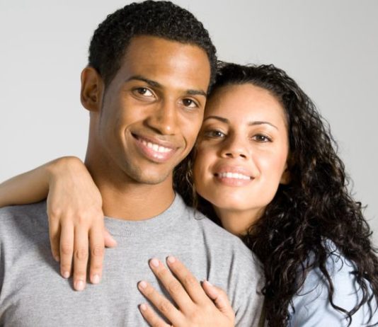 Close up shot of a couple smiling to camera.