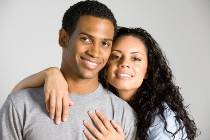 Close up shot of a couple smiling to camera.