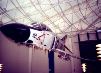 An airplane indoors, hanging from the rafters.