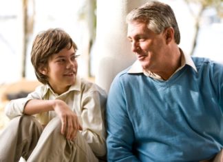 Father and son sitting side by side.