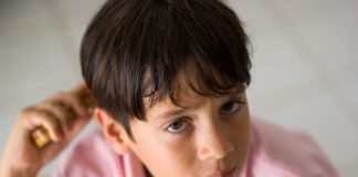 Boy combing hair