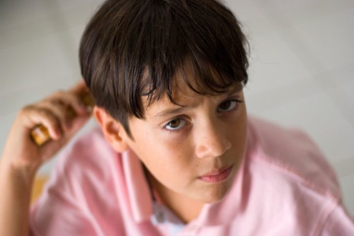 Boy combing hair