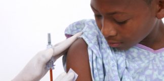 Boy in hospital gown about to get an injection