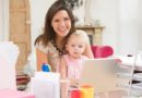 Mother and baby in home office with laptop