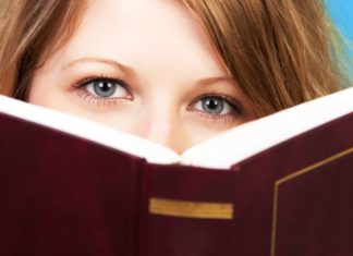 Teenager behind book