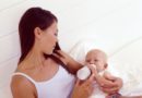 Woman feeding hungry baby with bottle.