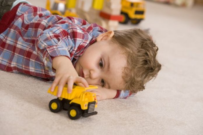 Boy playing with toy car