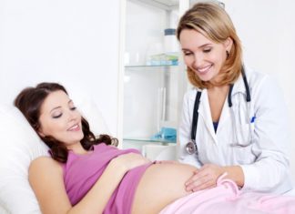 Doctor examining pregnant woman