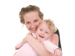 Smiling teen mum with baby.
