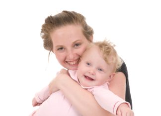 Smiling teen mum with baby.