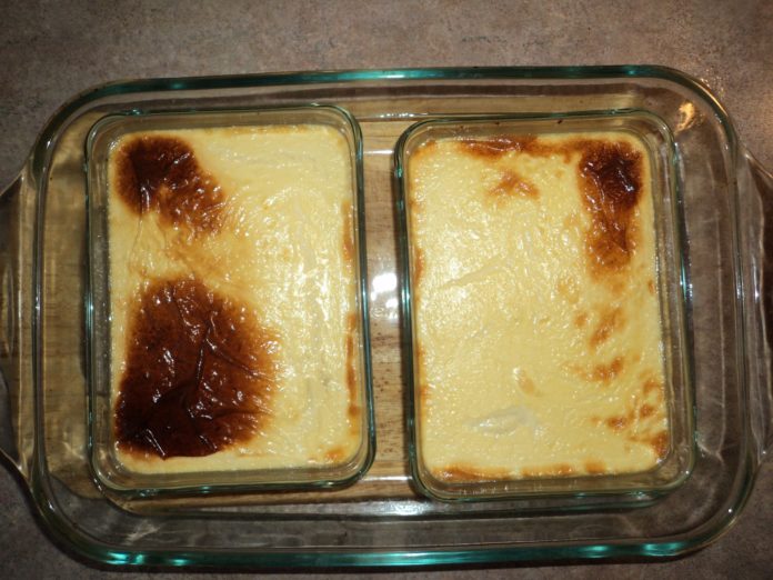 Freshly baked custard. Two smaller casserole dishes sit inside a larger dish.