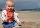 baby playing in the sand